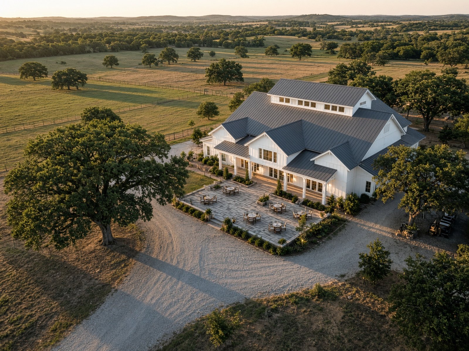 Aerial photograph of a Texas barn wedding venue and event grounds at golden hour